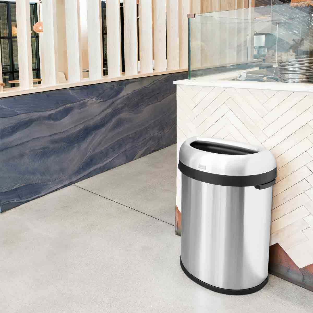 Lifestyle view of Simplehuman 80L Semi-Round Open Can, Brushed Stainless Steel, space-saving for commercial areas.
