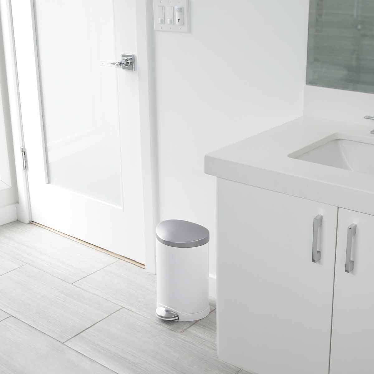 Simplehuman 6L Semi-Round Step Can, White/Brushed Steel, hands-free pedal fits against wall in bathroom.