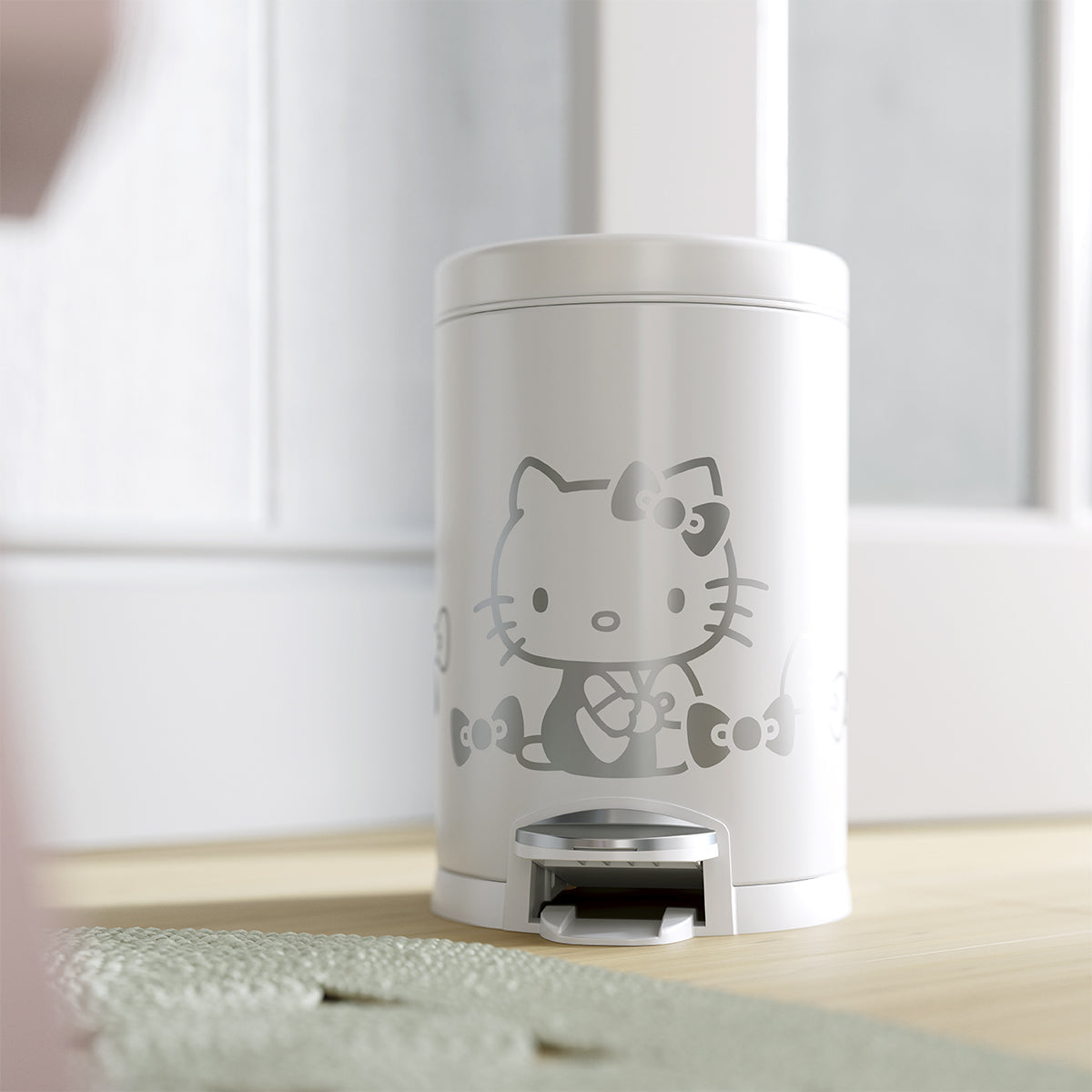 Lifestyle close-up of Simplehuman 4.5L Round Step Can, White/Silver Hello Kitty, hands-free pedal for kids' rooms.