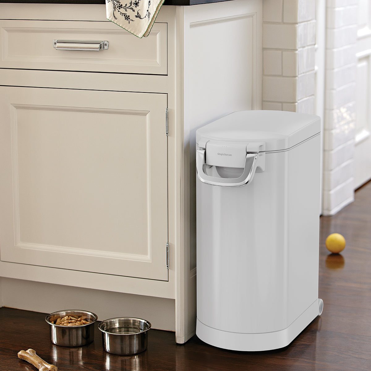 Simplehuman White Large Pet Food Can in kitchen, closed with airtight locking handle, next to pet bowls.