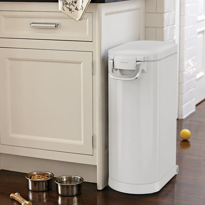 Kitchen view of Simplehuman White X-Large Pet Food Can next to pet bowls. Airtight locking handle and mobility wheels.