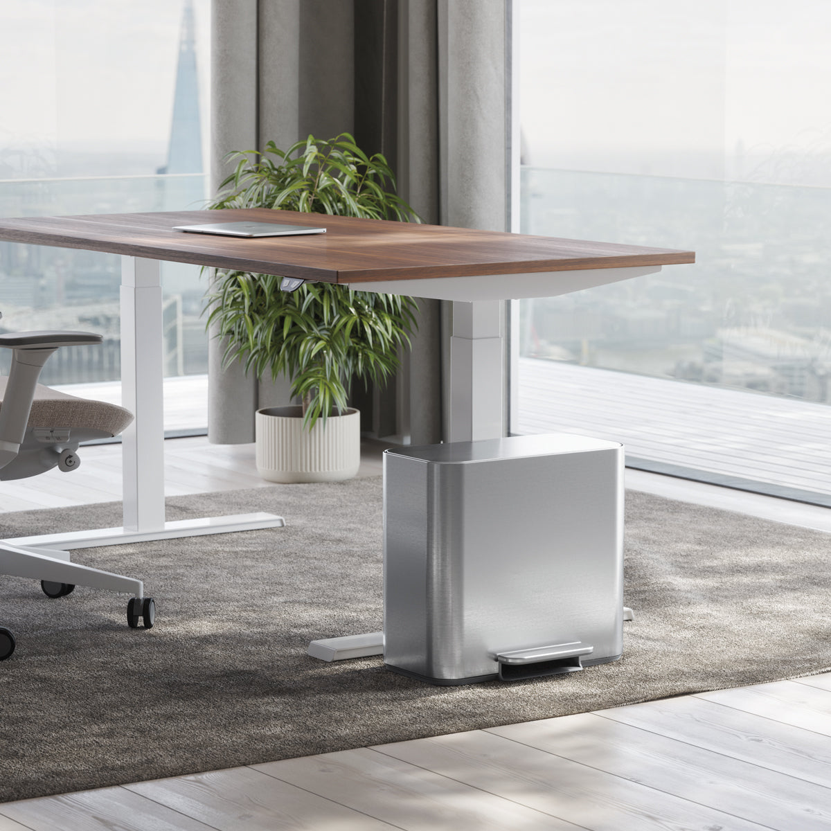 Simplehuman Brushed Stainless Steel 15L Mini Recycler Step Can under a desk, space-saving design with hands-free foot pedal.