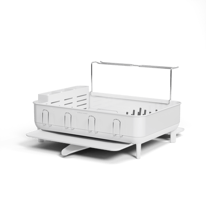 Angled view of Simplehuman White Steel Frame Dishrack, featuring raised handle, utensil caddy, and integrated cup hooks.