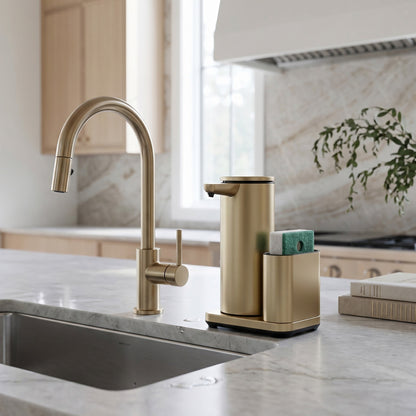 Simplehuman's 14 oz. Liquid Sensor Pump with Caddy in Matte Gold in a modern kitchen setting with marble countertops and backsplash featuring wooden cabinets.